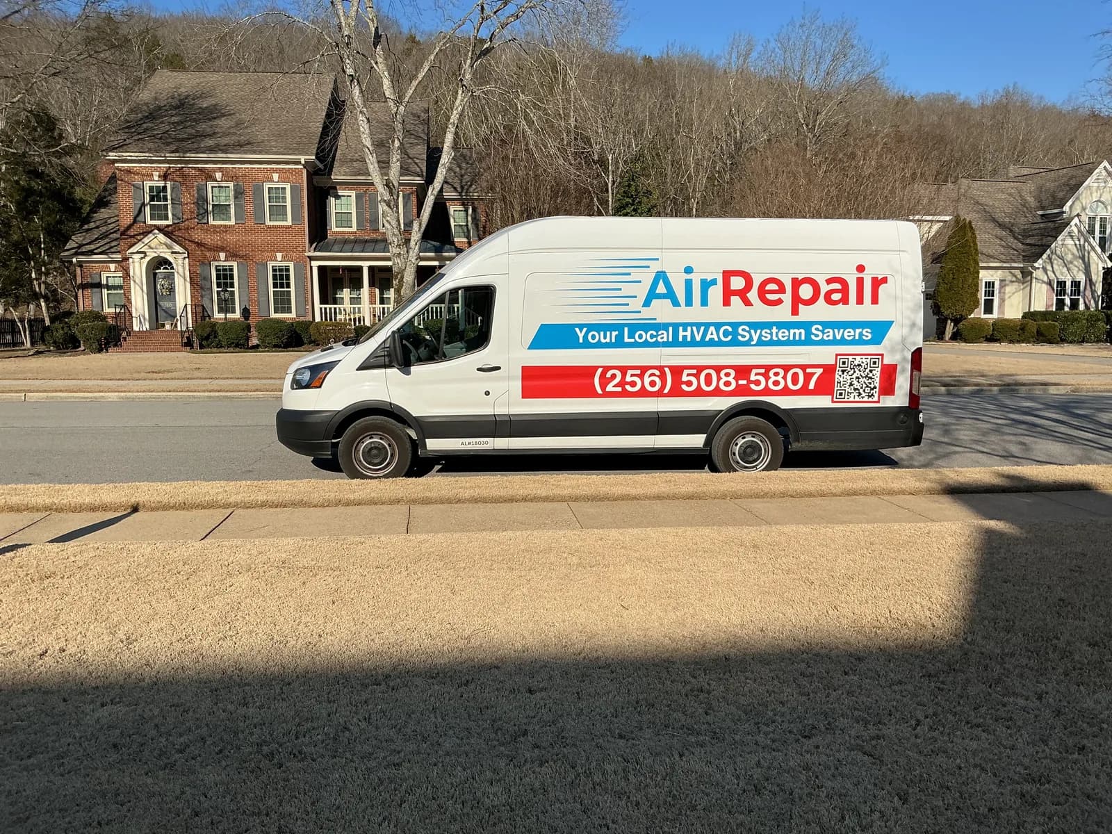 AirRepair van parked at a customer's home in a Huntsville neighborhood